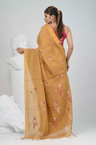 Beige tissue saree with ethnic motifs and golden border