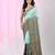 Sea green cotton saree with intricate striped border and tassels