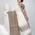 Off white cotton saree with intricate striped border and tassels
