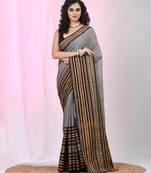 Grey cotton saree with intricate striped border and tassels