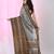 Grey cotton saree with intricate striped border and tassels