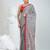 Grey handwoven cotton saree with red border and traditional motifs