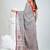 Grey handwoven cotton saree with red border and traditional motifs