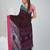 Brown cotton saree with pink and teal border & leaf design