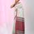 Elegant ecru cotton saree with red and green diamond motifs