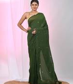 Elegant green cotton saree with sequin embellishments and pom pom