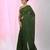 Elegant green cotton saree with sequin embellishments and pom pom