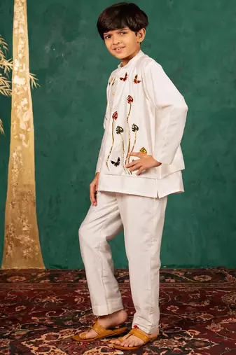 Boys white silk kurta and pants with handwork acrylic bundi jacket