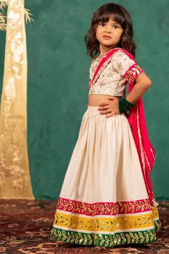 Girls off-white elbow sleeve top and lehenga with georgette dupatta
