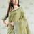 Pista green color linen fabric sophisticated floral embroidered saree