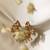 Gold plated temple pearl dangler earrings