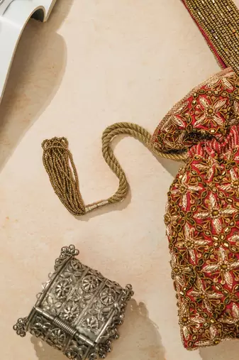 red silk floral embroidered potli bag with beaded handle