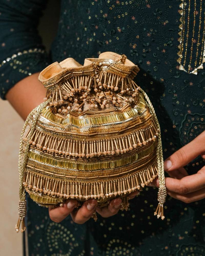 Gold silk embroidered potli bag