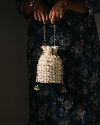 white pearl embroidered silk potli bag for festive wear 1