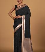 Black color elegant banarasi silk saree with gold zari weaving work comes with unstitched blouse piece