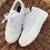 White solid synthetic sneakers