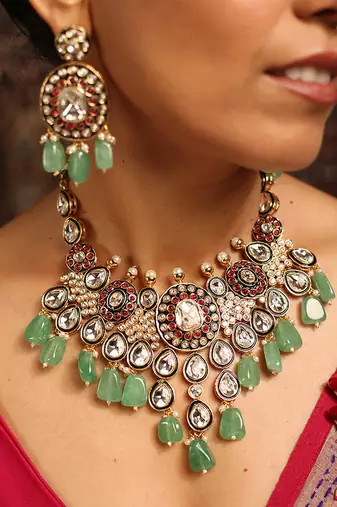 Traditional kundan necklace set with green beads and red accents