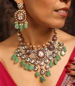 Traditional kundan necklace set with green beads and red accents
