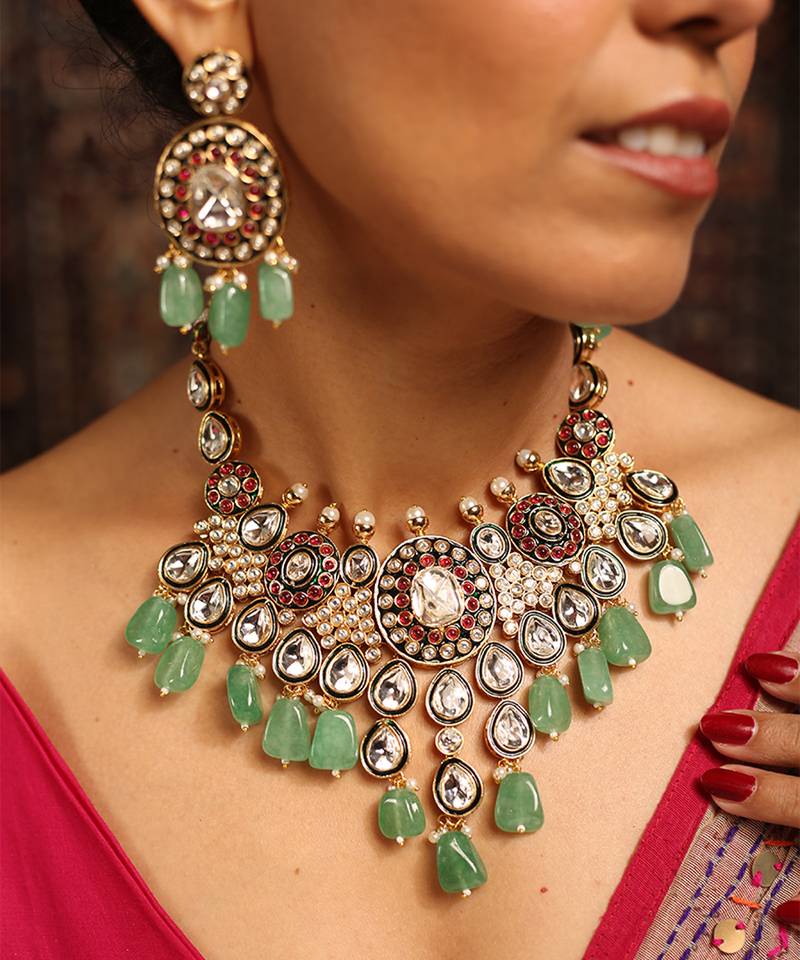 Traditional kundan necklace set with green beads and red accents