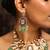 Traditional kundan necklace set with green beads and red accents