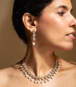 Elegant gold-toned traditional necklace and earring set with pearl accents