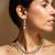 Elegant gold-toned traditional necklace and earring set with pearl accents