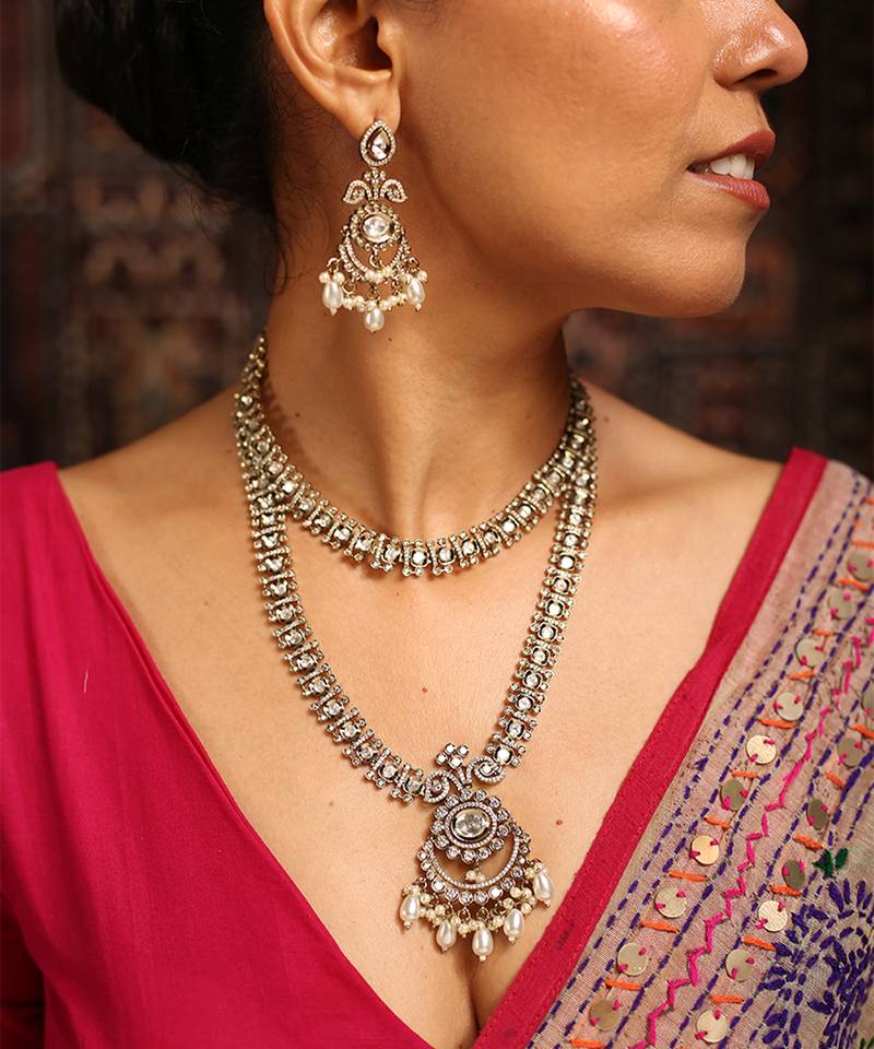 Stunning gold-toned diamond necklace set with clear stones and pearl drops