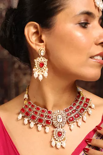 Traditional red stone choker necklace set with pearls and maang tikka