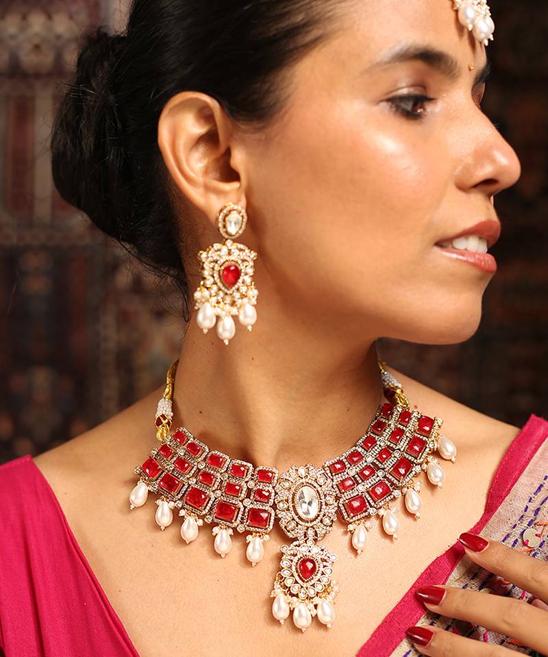Traditional red stone choker necklace set with pearls and maang tikka