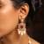 Traditional red stone choker necklace set with pearls and maang tikka