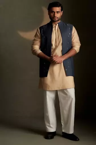 Blue embroidered chanderi nehru jacket paired with beige kurta set