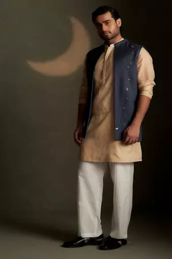 Blue embroidered chanderi nehru jacket paired with beige kurta set