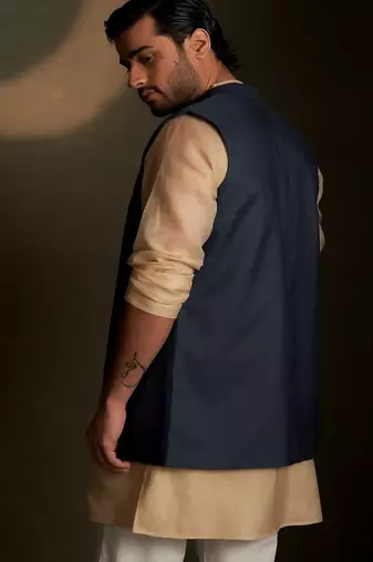 Blue embroidered chanderi nehru jacket paired with beige kurta set