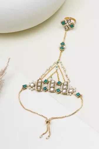 Gold-plated haathphool with emerald accents