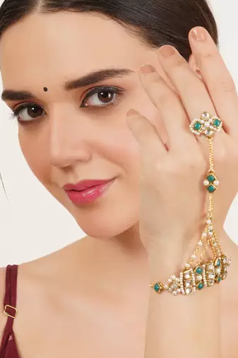 Gold-plated haathphool with emerald accents