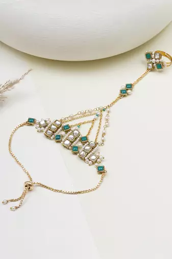 Gold-plated haathphool with emerald accents