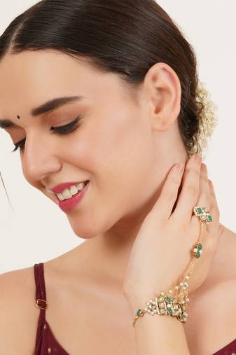 Gold-plated haathphool with emerald accents