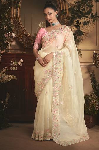 Designer cream tissue organza saree with all over butta work & heavy stone embellished border
