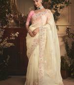 Designer cream tissue organza saree with all over butta work & heavy stone embellished border