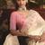Designer cream tissue organza saree with all over butta work & heavy stone embellished border