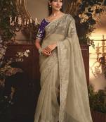 Designer beige tissue organza saree with all over butta work & heavy stone embellished border