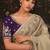 Designer beige tissue organza saree with all over butta work & heavy stone embellished border