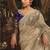 Designer beige tissue organza saree with all over butta work & heavy stone embellished border