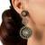 Gold plated green stone kundan dangler earrings