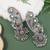 Silver plated oxidised multistone peacock ear cuff with jhumka for women (e3399ox)