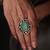 Gold plated kundan green stone ring