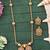 Antique gold-plated designer chain pendant set with earrings – red & green stone embellishments