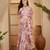 Pastel pink linen silver zari digital print saree with latkan tassel pallu & belt