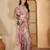 Pastel pink linen silver zari digital print saree with latkan tassel pallu & belt