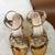 Gold embroidered leather heels